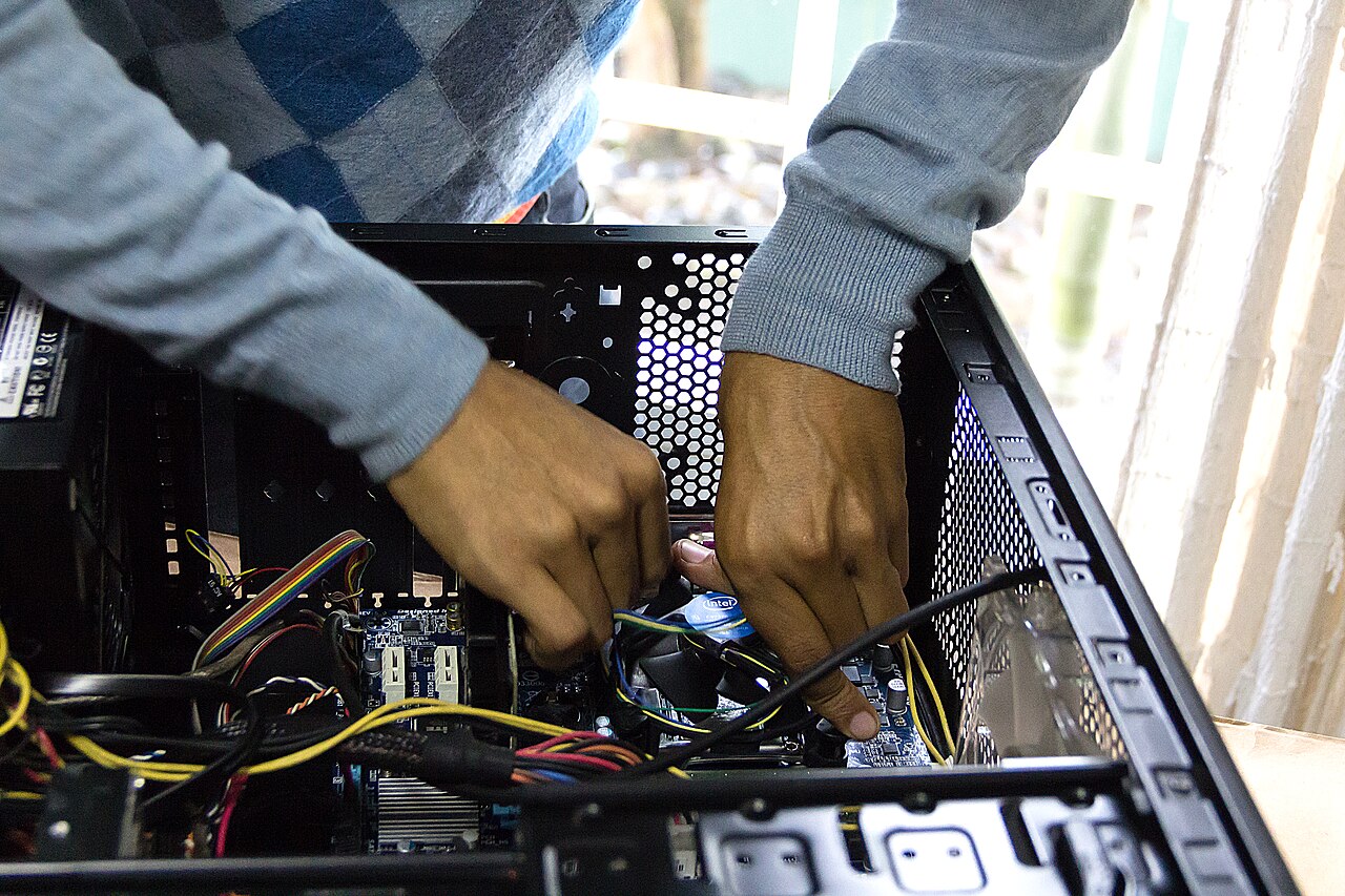 Cape Load Digital technician working inside a desktop computer
